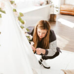 Ashley Minor attached florals to a glamping tent