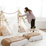 Erica Haynes arranges florals on a glamping tent