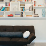 Styled-built-in-bookshelf-behind-dark-fabric-couch
