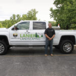 Lance-Lanier-standing-in-front-of-his-work-truck