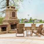 Wide-angle-shot-of-outdoor-fireplace-built-with-stone-and-brick