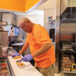 Jeff-preps-a-chili-dog-behind-the-counter