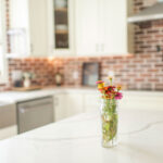 small-jar-of-colorful-flowers-on-kitchen-island-in-kitchen