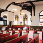 Interior-of-church-red-pews-and-stained-glass-windows