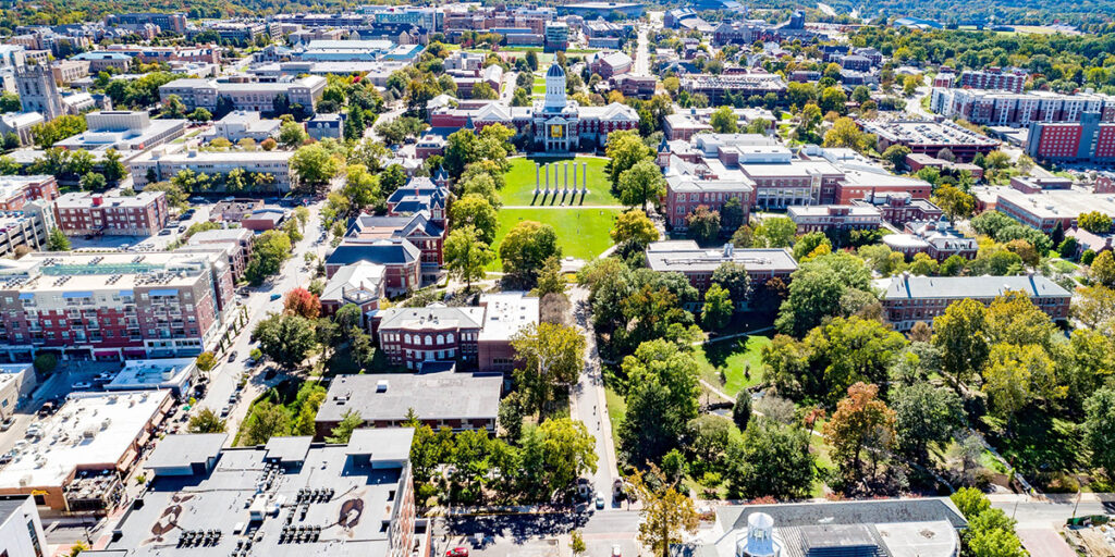 A bird's-eye view of downtown Columbia looking south toward and over the Mizzou campus, with Jesse Hall in the background.