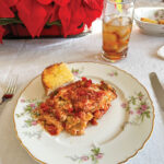Lasagna-on-flower-painted-porcelain-plate-iced-tea-and-red-poinsettias