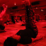 Sauna-Yoga-under-heat-lamps-participants-feet-in-the-air