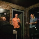Left to right; Rob Harris, Michael Yetman, Harley Bushdiecker chat in the greenroom of the Blue Note before performing at Pints and Punchlines