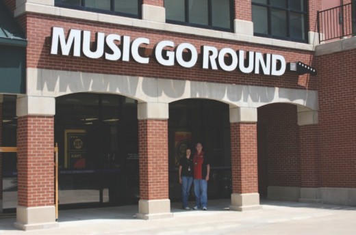 Music Go Round owners Amanda and Gary Taylor stand in front of their new store in The Broadway Shops on East Broadway in Columbia. 