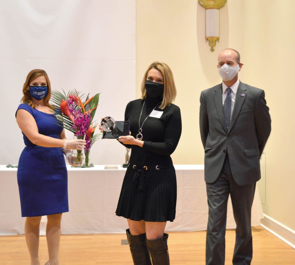 Sarah Hill receives the ATHENA Young Professional Award while wearing masks