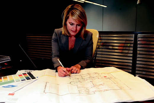 Bridgid Miller goes over plans for a commercial client's electronic system.