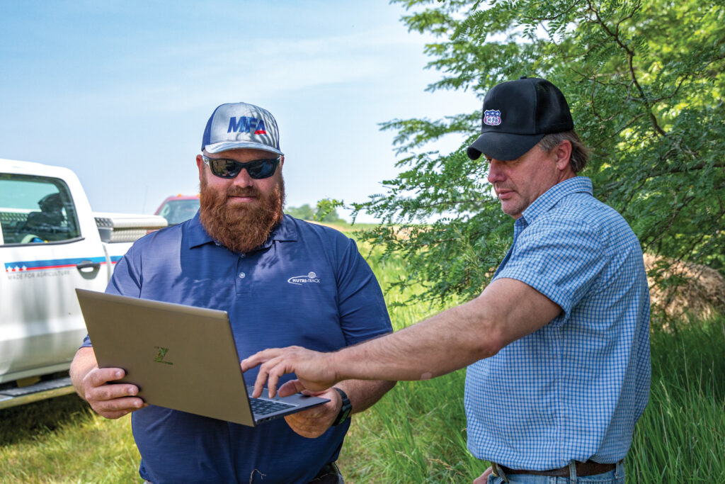 MFA Precision Specialist Cory Clermont, left, and producer Ross Davis look at field nutrient maps to discuss where corn plants could benefit from in-season fertilizer.