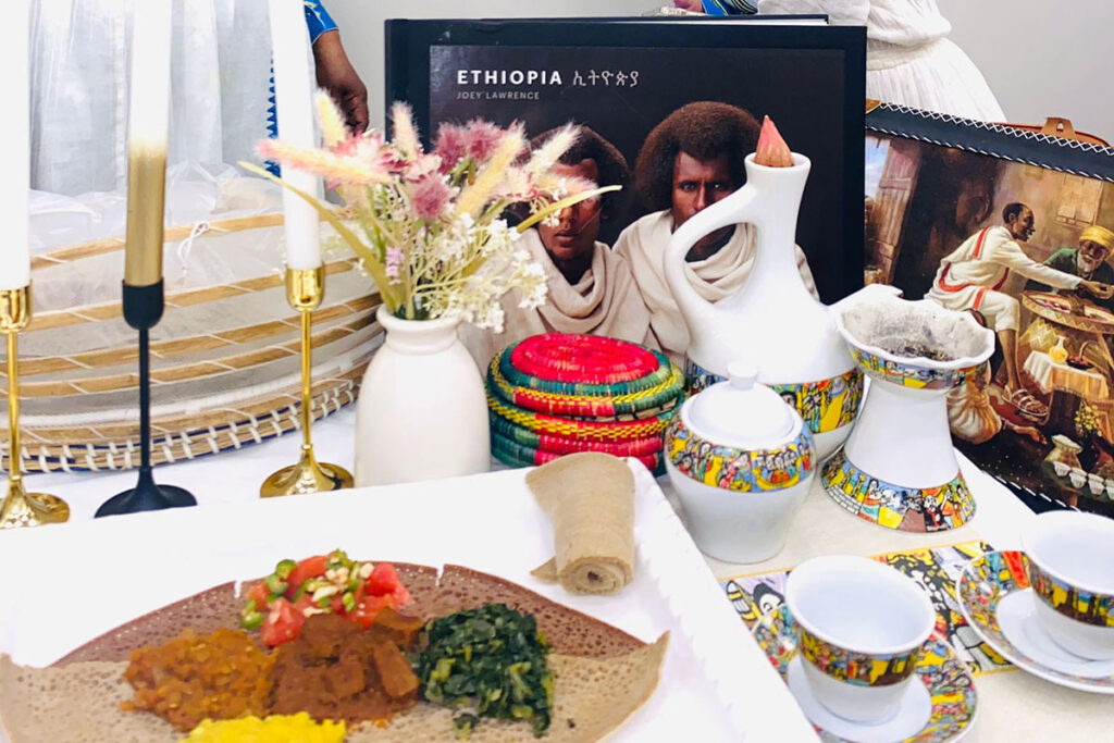 A beautifully arranged table setting from Mahalet Tesafaye's first Ethiopian pop up at Christian Fellowship Church features split peas wot (stew), red lentils, shiro, gomen, atikilt wot, cabbage, and carrots.