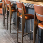 Detail Shot Of Organic Industrial Metal And Leather Bar Stools