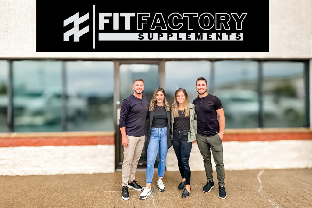 Fit Factory owners pose in front of storefront.