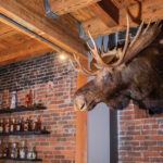 Moose Head Taxidermy Decoration On A Brick Wall In A Bar