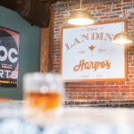 The Landing At Harpos Sign Hangs On A Brick Wall