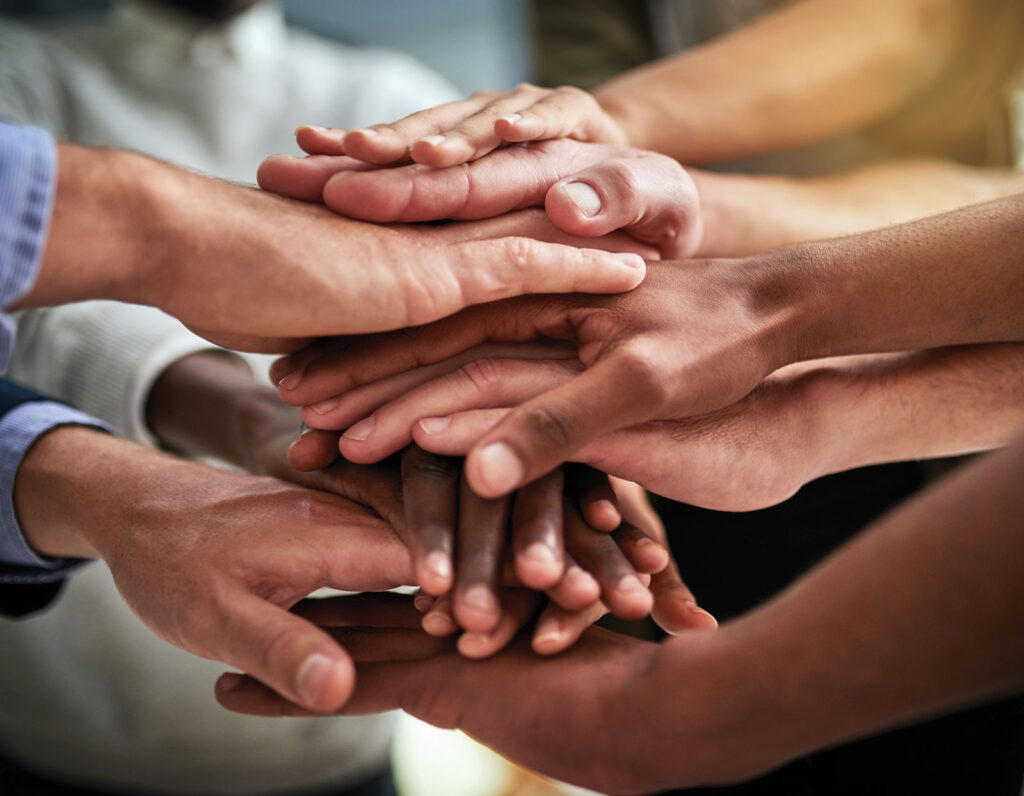 Hands In Stacked For Teamwork