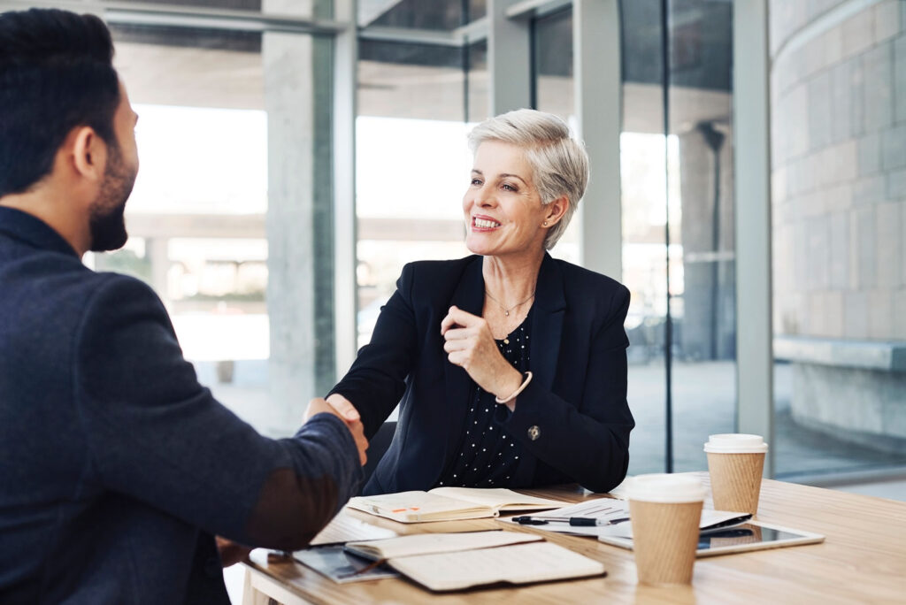 Mid America Bank: Two Businesspeople Shaking Hands During a Meeting