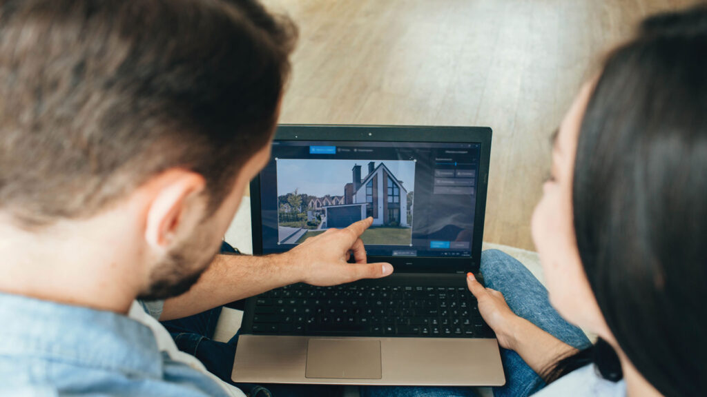 A Couple Looking At Homes On Their Laptop