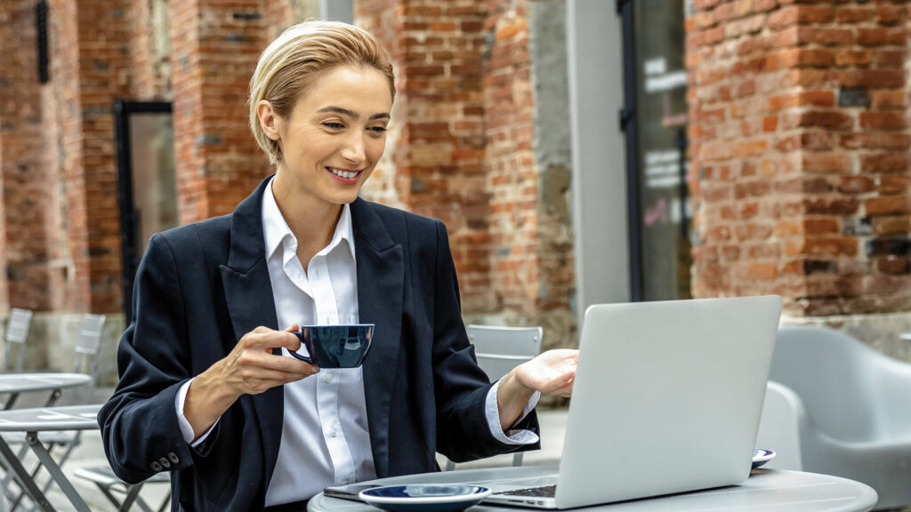 Young Fair Haired Woman Working On Laptop And Looking Involved