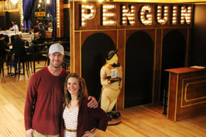 Gia and Rob Reade in front of the Penguin restaurant and piano bar in downtown Columbia, Missouri.