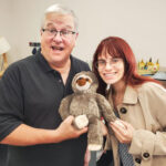 COMO Business Times editors Jodie Jackson Jr and Kelsey Winkeljohn, posing with a stuffed sloth