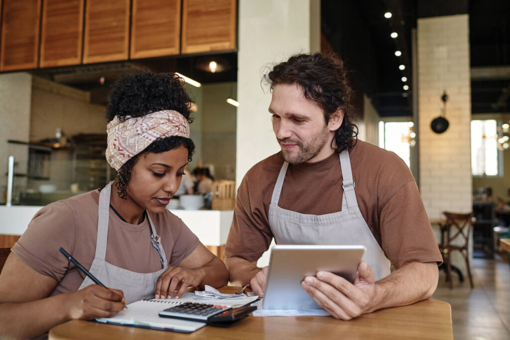 Small Business Owners Looking at Paperwork