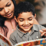 Woman Holding Young Child Reading