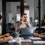 A Young Business Man Talking To A Group Of Professionals