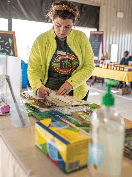 Columbia Farmers Market Staff Setting Up Info Table