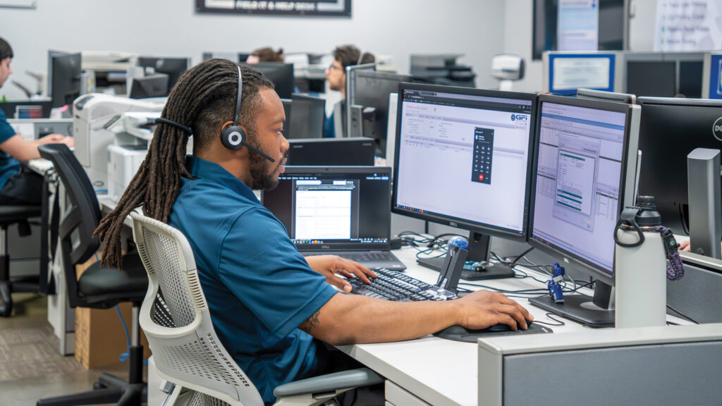 GFI Employee Sitting At A Help Desk