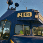 Railroad operator James Day sitting In front of locomotive 1200x800