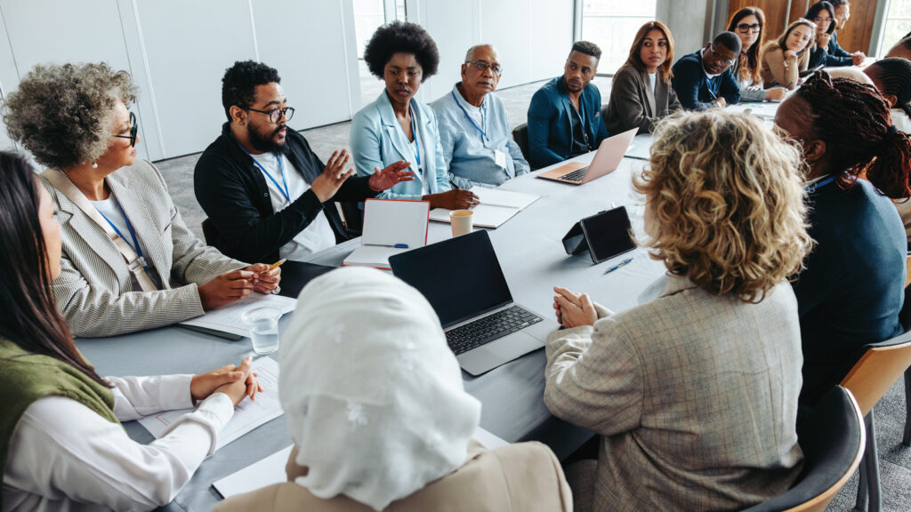 Featured Group Of Community Members Engaged At A Board Meeting
