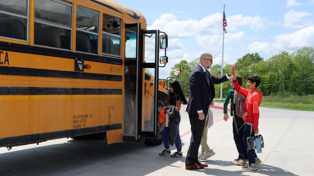 Dr Jeff Klein Cps Superintendent High Fives Students Next To School Bus