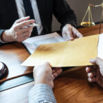 Featured Lawyer And Client Exchanging Title Insurance Papers