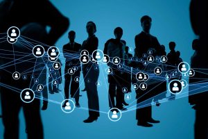 Silhouettes of people mingle and stand to illustrate how technology connects us all