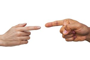 Fingers pointing at each other to illustrate debating and arguing.