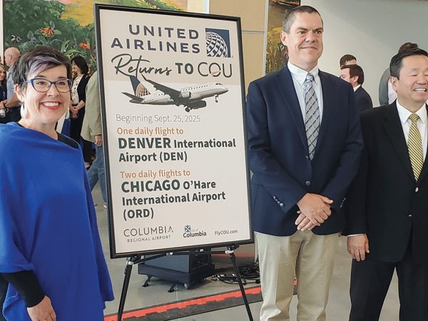 Columbia Mayor Barbara Buffaloe, left, COU Manager Michael Parks, and University of Missouri System President Mun Choi display the announcement that United Airlines will begin flights from COU on September 25.