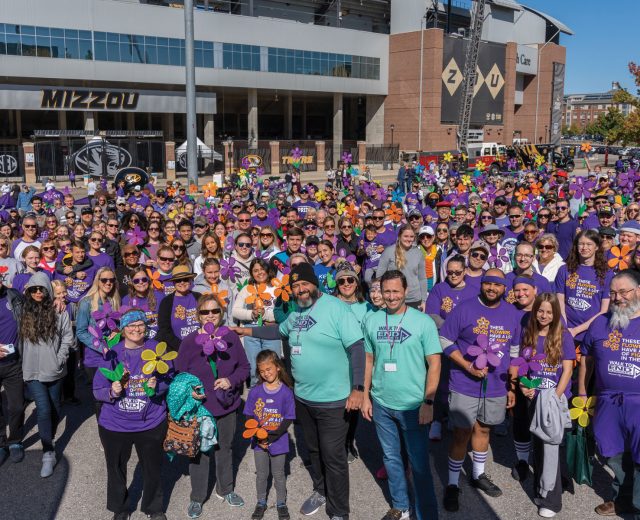 A-Sea-of-faces-wearing-purple-in-front-of-the-MU-arena-preparing-to-walk-to-support-Alzheimers