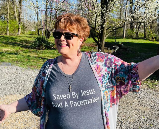 Cindy-Mutrux-in-a-shirt-that-says-Saved-by-Jesus-and-a-pacemaker