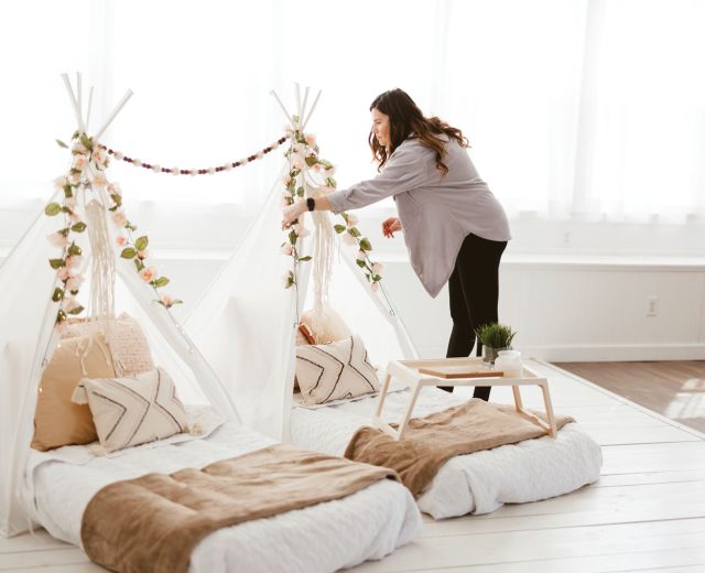 Erica Haynes arranges florals on a glamping tent