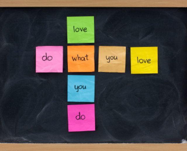 do what you love, love what you do - happy life and work concept presented on blackboard with colorful sticky notes, white chalk smudges