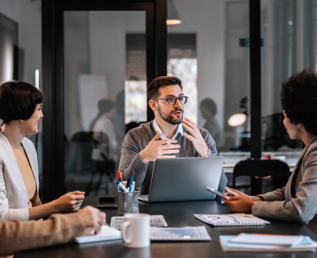 A Young Business Man Talking To A Group Of Professionals