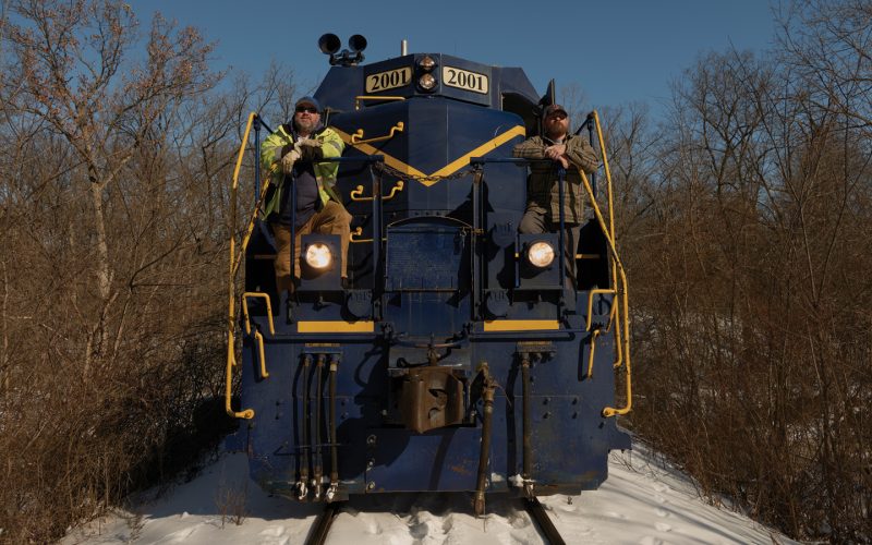 Featured Colt Railroad Operators Matthew Sabath And James Day Stand On The Train Exterior