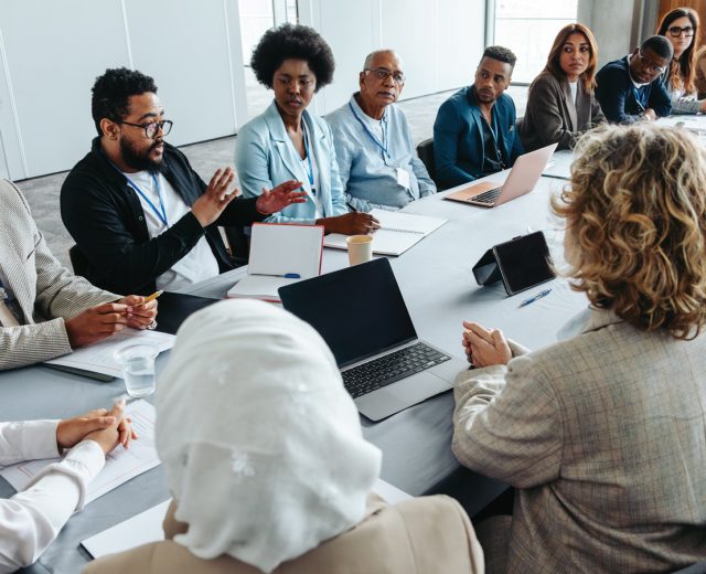 Featured Group Of Community Members Engaged At A Board Meeting