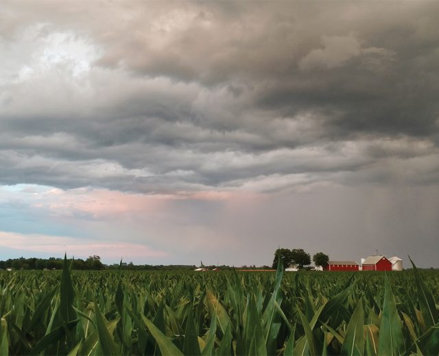 Mental Health and Farmers illustrated with a landscape image of a barn with a storm brewing overhead.