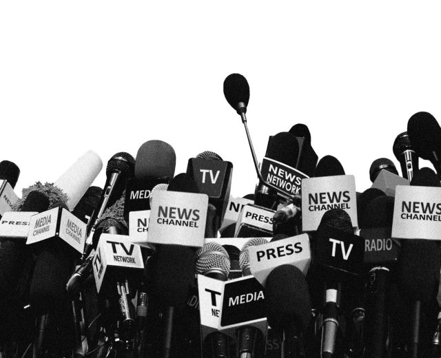 press-microphones-clustered-together-as-if-in-front-of-a-candidate