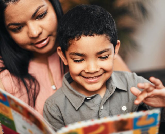 Woman Holding Young Child Reading